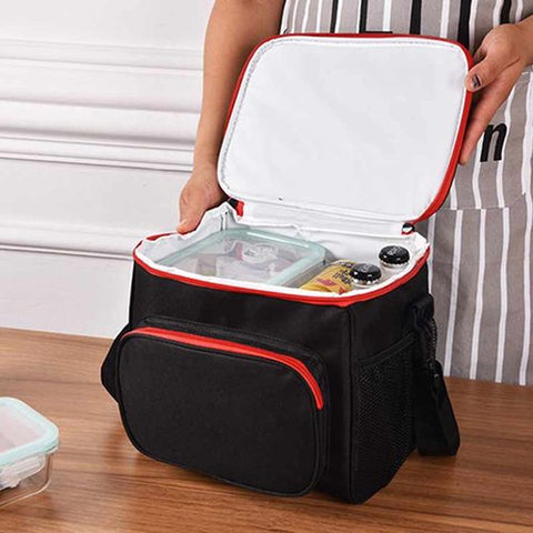 A black insulated bag with red trim that has food inside