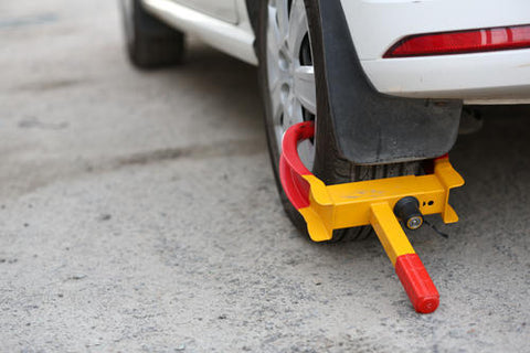 A wheel lock on a white car