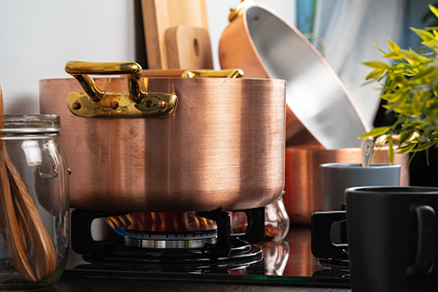 Some pots on a gas stove heating up food