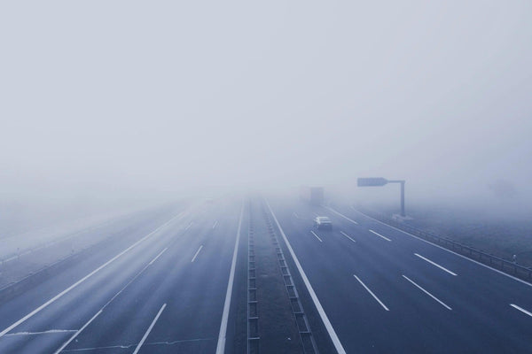 Cars on a highway in foggy weather