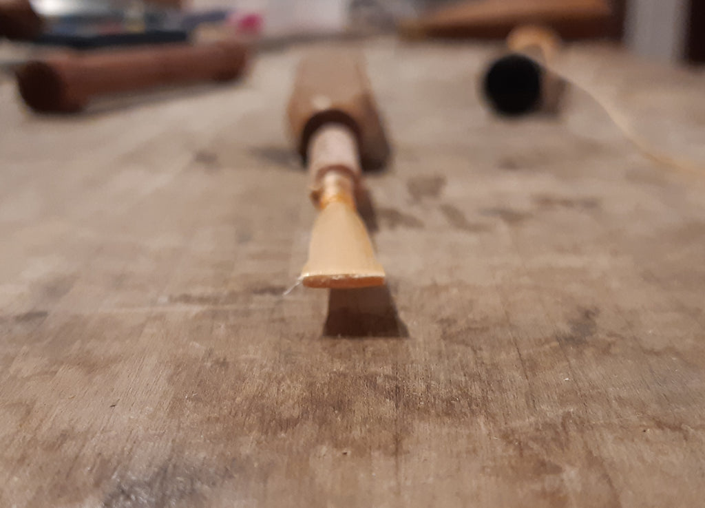 A tied oboe reed blank, checking the rotational alignment