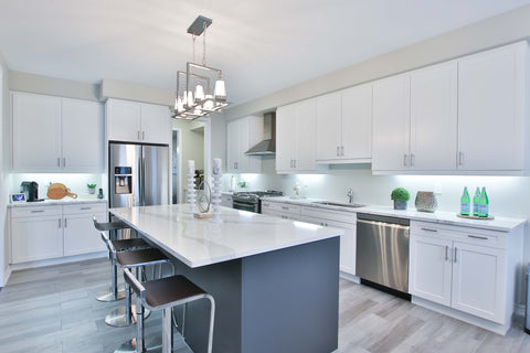 a kitchen with rectangular white wooden table