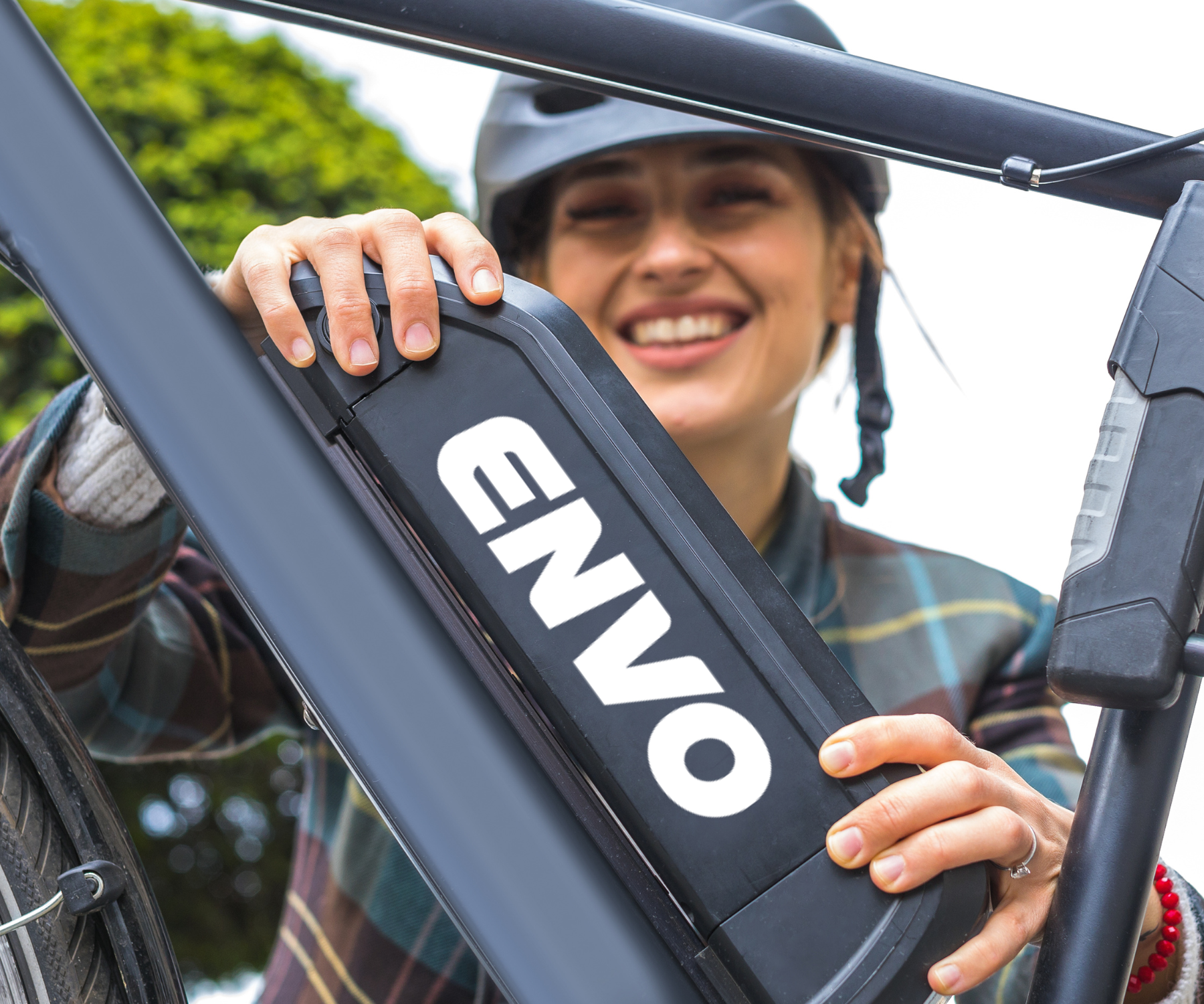 Happy woman changing ebike battery | ENVO
