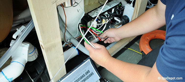 hands removing wires from circuit board