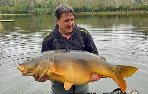 68lb carp being held by fisherman, Jean.