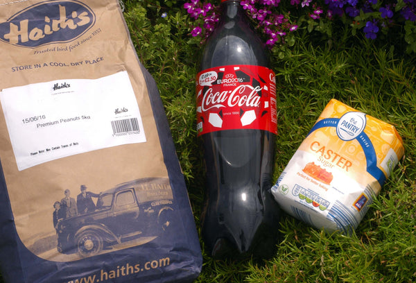 Bag of Haith's premium peanuts, bottle of coke and caster sugar ingredients for fishing bait.