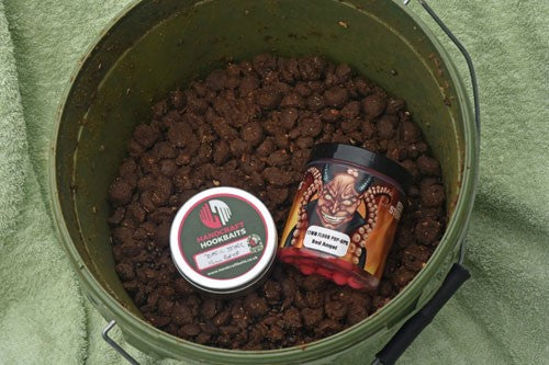 Brown-red bait in a green bucket.