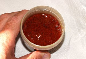 Jar of red liquid bait paste.