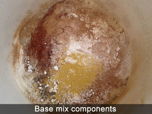 Fishing bait ingredients in a mixing bowel - coloured powders.