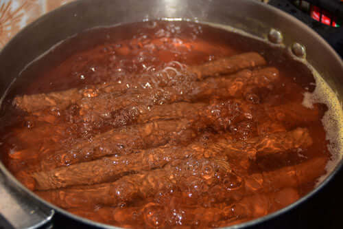 Boil the sausages in a pan