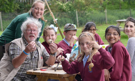 Year 6 pupils showing there homemade bird feeders