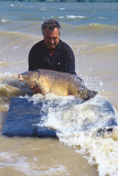 A carp caught on choppy waters at Lake Sarulesti.
