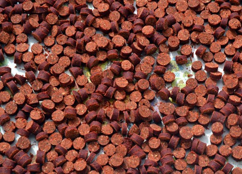 Brown-red boilies chopped up into circles.