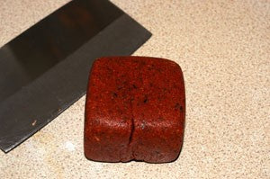 Dark red block of fishing bait, on a spatula.