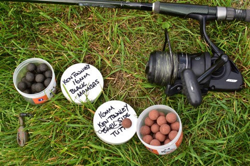 Bait, rig and tackle laid out on grass.