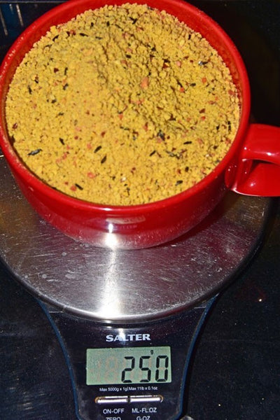 Haith's Red Factor in a large red mug, on a set of scales.