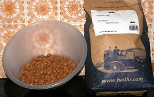 Haith's tiger nuts in a bowel next to brown paper packaging.