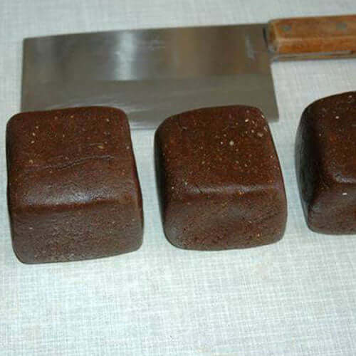 Image-4-I-now-divide-the-big-ball-of-paste-into-four-and-shape-them-into-squares-using-a-large-flat-kitchen-cleaver.