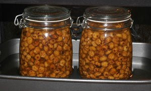 Large jars of tiger nuts on a baking tray.