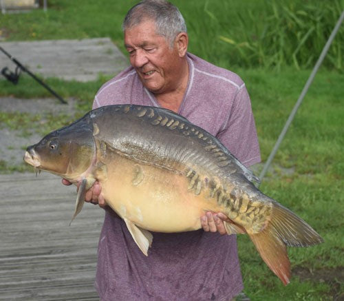 Ken holding a giant 40lb 12oz carp he caught.