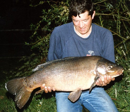 A young Ken Townley holding his carp catch.