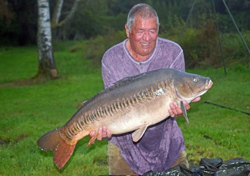 Ken holding a shiny carp.