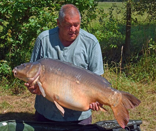Ken holding a large carp.