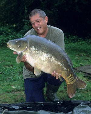 Ken Townley holding a large carp.