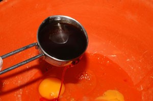 Liquid attractor being poured into a bowel of broken eggs.