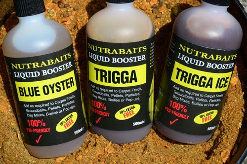 Three bottles of liquid boosters for fishing.