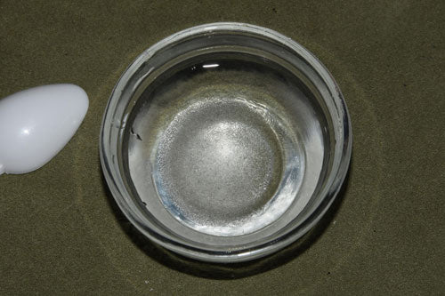 the HCL has been emptied into the water. You can see the crystals on the bottom of the bowl.