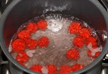 Image of individual red balls in boiling water