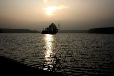 Image of a lake with an island in the middle at sunset