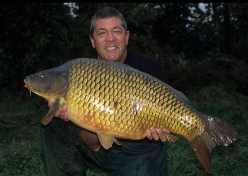 Photo of Ken Townley holding a large carp