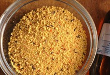 Image of yellow powder bird food in a bowl