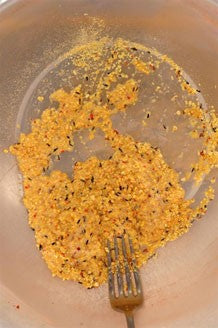 Image of yellow bird food base mix blended with attractor