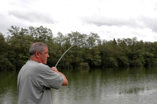 Photo of Ken Townley stood by a lake fishing