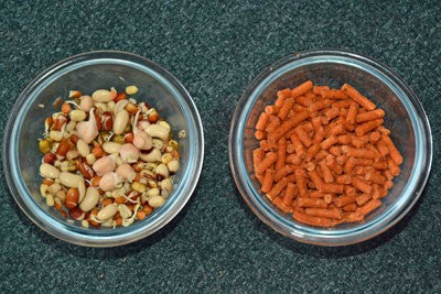 Image of two bowls, one with sprouted seeds and pulses and one with red pellets