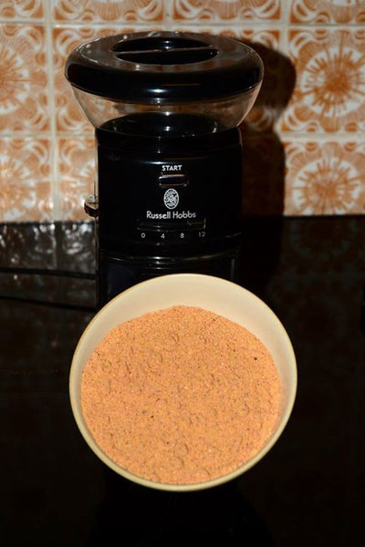 Photograph of a cream bowl of yellow fishing bait in front of a kettle