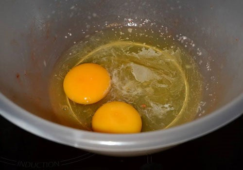 Photogragh of two uncooked eggs in a plastic mixing bowl