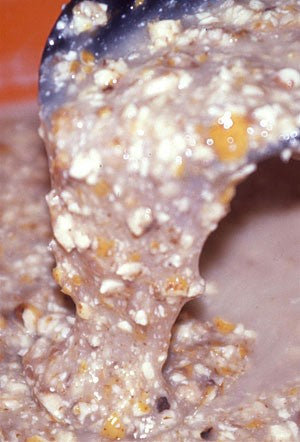 Photo of crushed tiger nuts in a black scoop