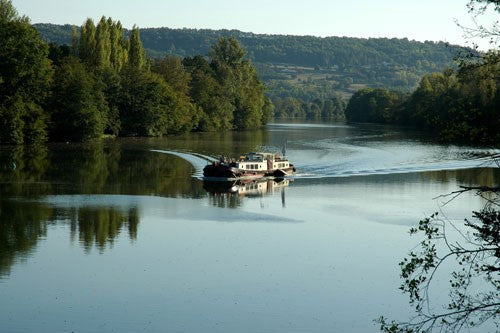 Image of a fishing lake with small boat in the middle of the lake