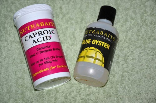 Image of a container of caproic acid and a second container which contains blue oyster attractor