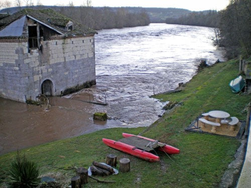 Image of a river in flood with a high riverbank
