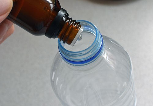 Caproic acid drops into water bottle.