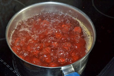 Photo of silver pan full of red round small boilies being boiled