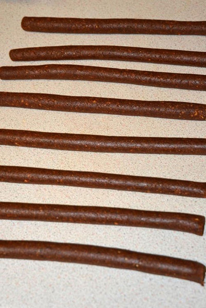 Photograph of fishing bait, lined up on a base of cream worktop