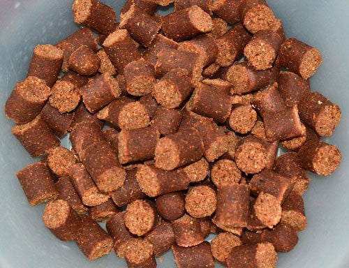 Photograph of bait which has been chopped into small sausage like pieces