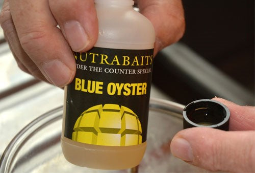 Photo of plastic container bottle containing blue oyster attractor