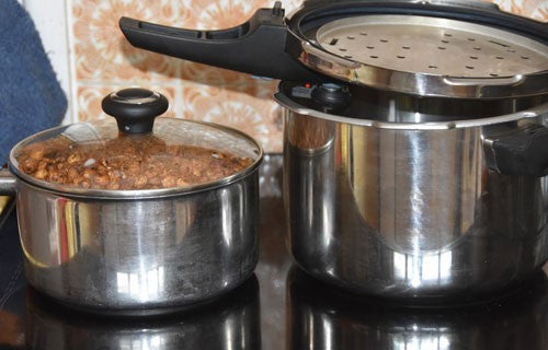 Saucepan next to a silver pressure cooker.